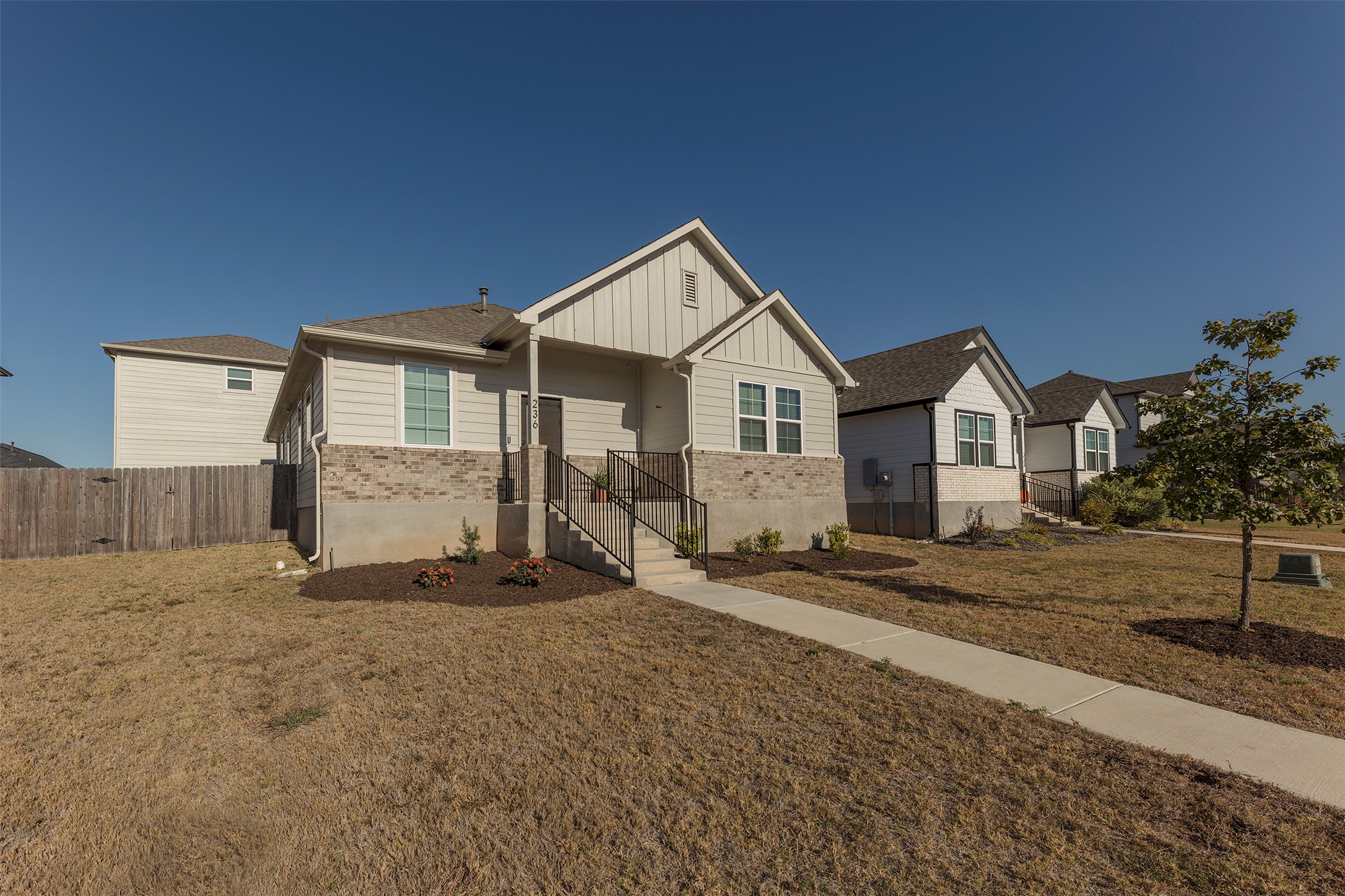 236 Garner Drive Kyle, TX 78640 - Photo 29 of 37 View of front facade featuring board and batten siding and brick siding