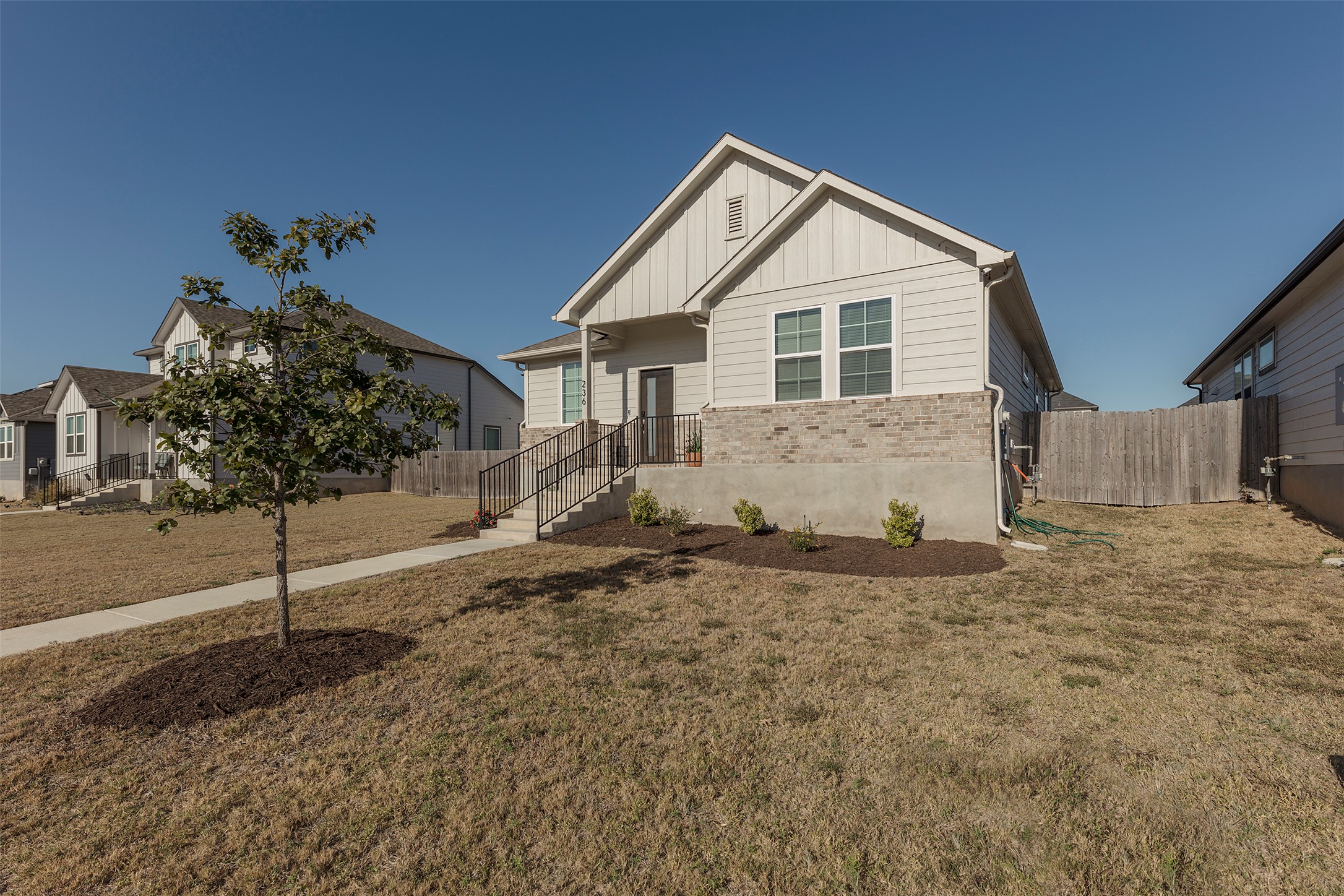 236 Garner Drive Kyle, TX 78640 - Photo 31 of 37 View of front of home featuring board and batten siding and brick siding