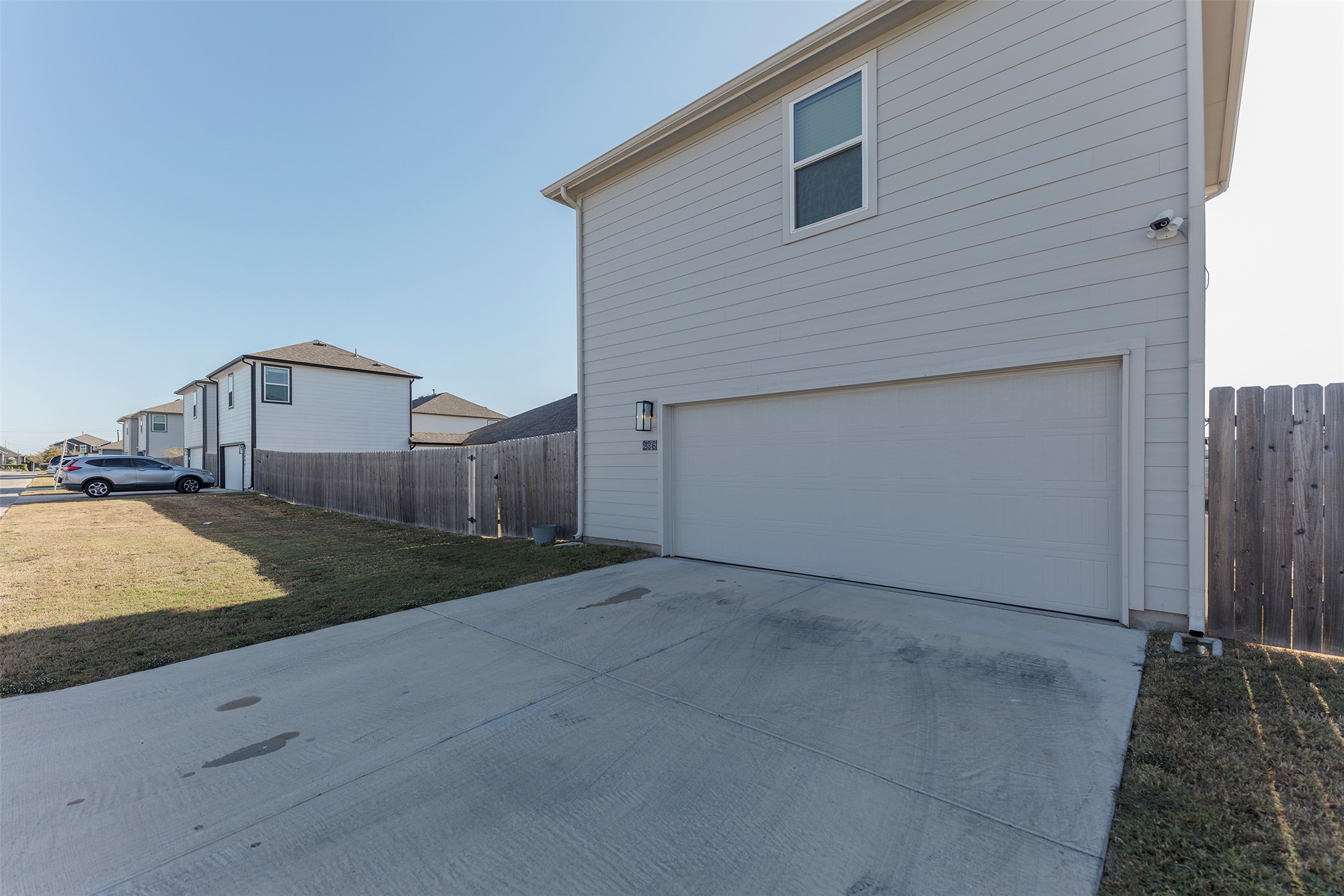 236 Garner Drive Kyle, TX 78640 - Photo 36 of 37 View of property exterior with an attached garage and driveway