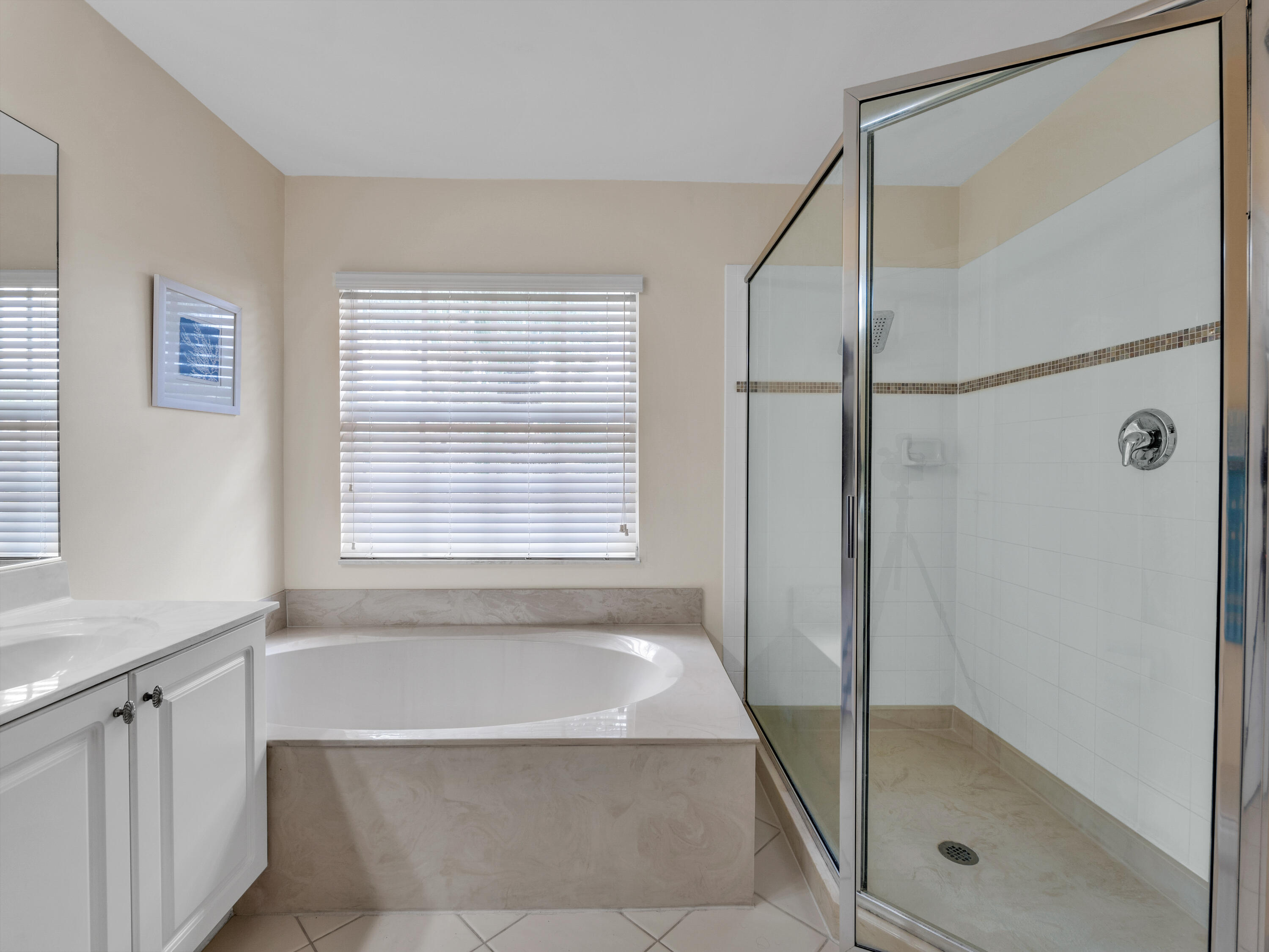 7951 Red Mahogany Road Boynton Beach, FL 33437 - Photo 18 of 33 a bathroom with a bathtub and shower