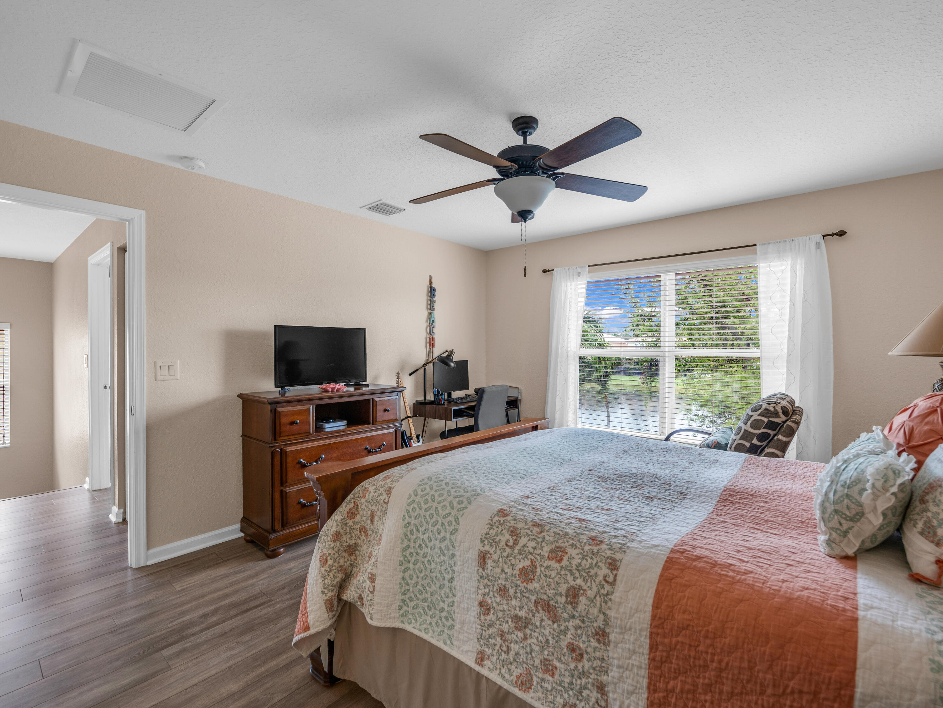 7951 Red Mahogany Road Boynton Beach, FL 33437 - Photo 20 of 33 a bedroom with a bed and a flat screen tv