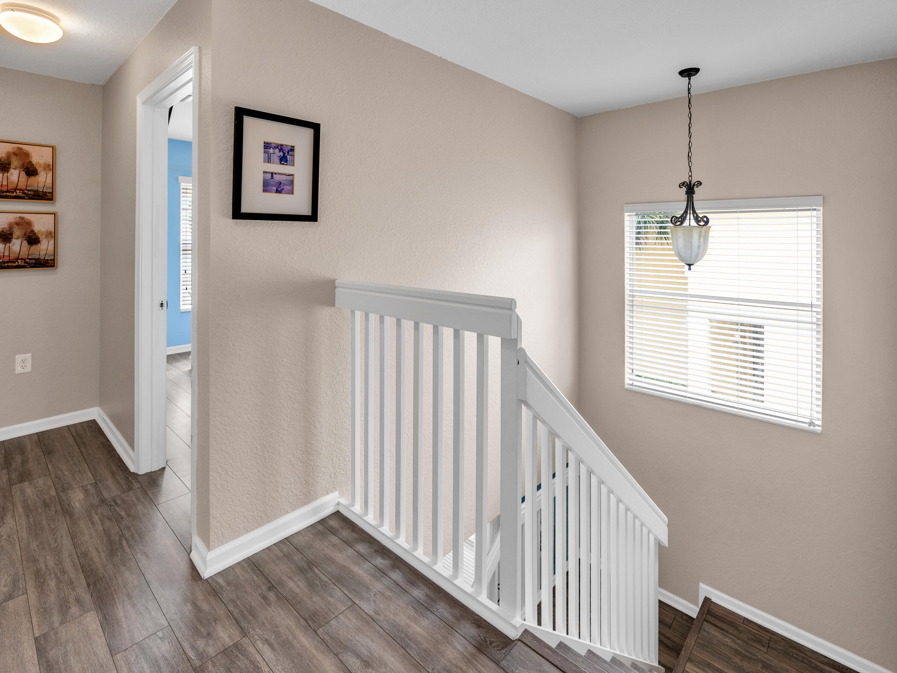 7951 Red Mahogany Road Boynton Beach, FL 33437 - Photo 24 of 33 a view of a hallway with a window and wooden floor
