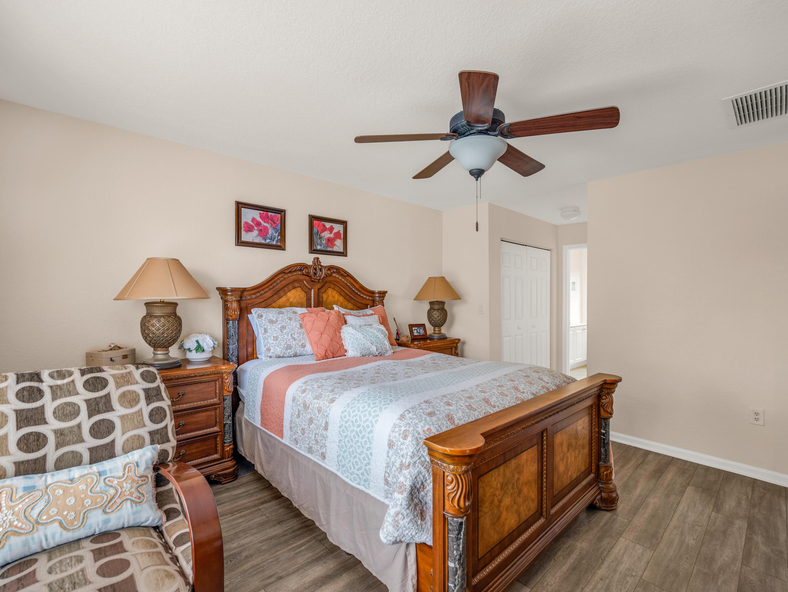 7951 Red Mahogany Road Boynton Beach, FL 33437 - Photo 27 of 33 a bed room with a bed and a chandelier