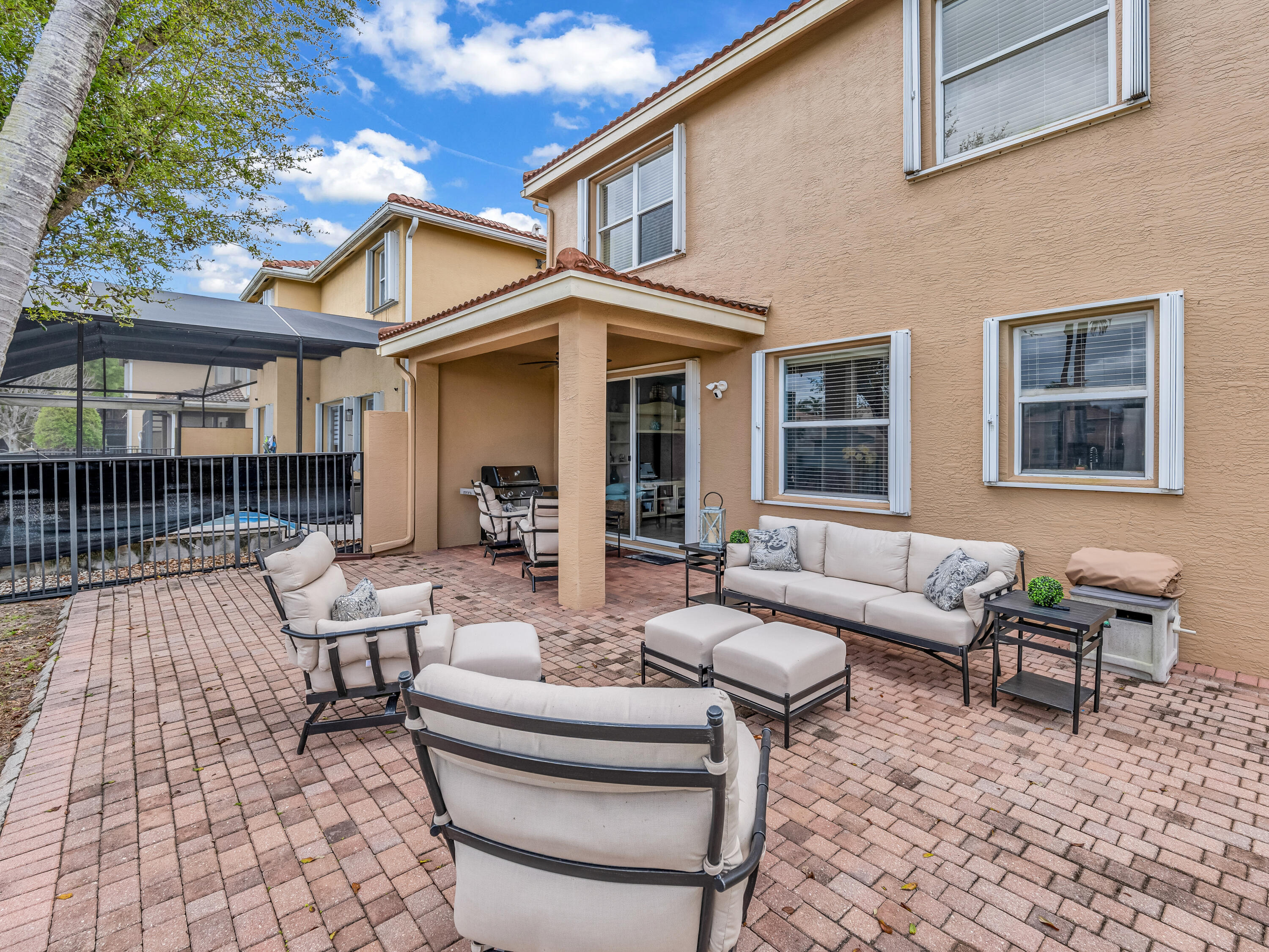 7951 Red Mahogany Road Boynton Beach, FL 33437 - Photo 29 of 33 a view of a patio with couches chairs and wooden floor