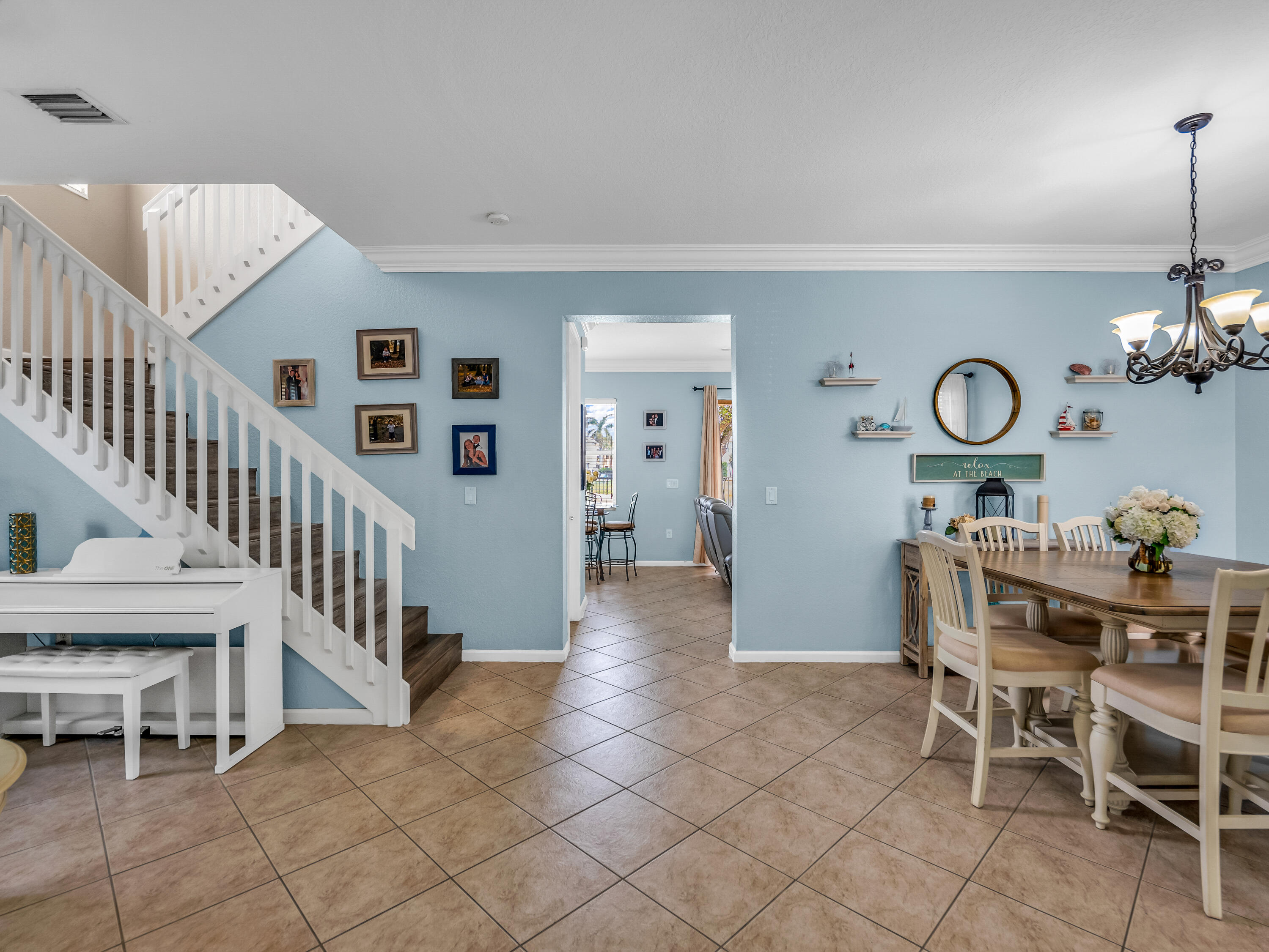 7951 Red Mahogany Road Boynton Beach, FL 33437 - Photo 7 of 33 a view of a livingroom with furniture and staircase
