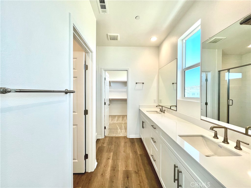 27391 Powder Ridge Court Valencia, CA 91381 - Photo 11 of 22 a spacious bathroom with a double vanity sink and mirror