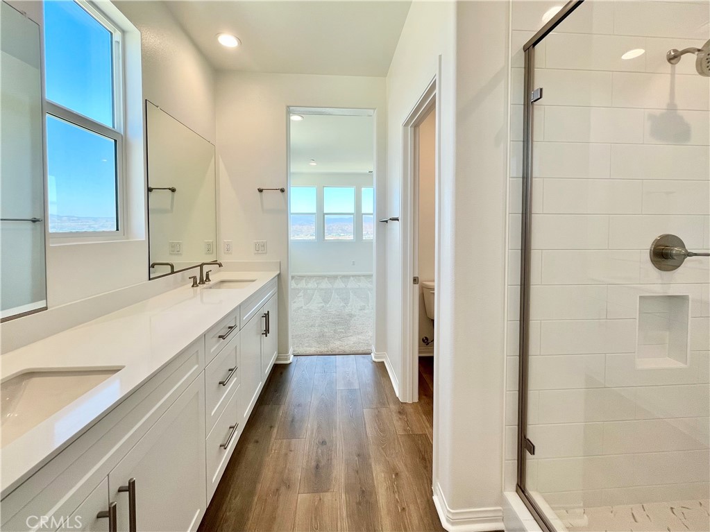 27391 Powder Ridge Court Valencia, CA 91381 - Photo 12 of 22 a spacious bathroom with a double vanity sink a mirror and shower