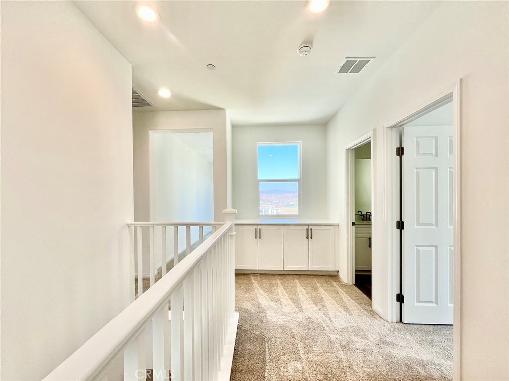 27391 Powder Ridge Court Valencia, CA 91381 - Photo 14 of 22 a view of a hallway with wooden floor and staircase