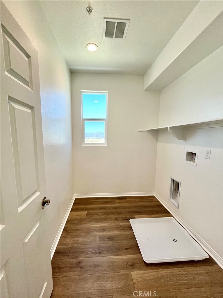 27391 Powder Ridge Court Valencia, CA 91381 - Photo 20 of 22 an empty room with wooden floor and windows