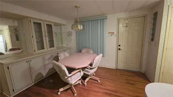 a room with wooden floors and furniture