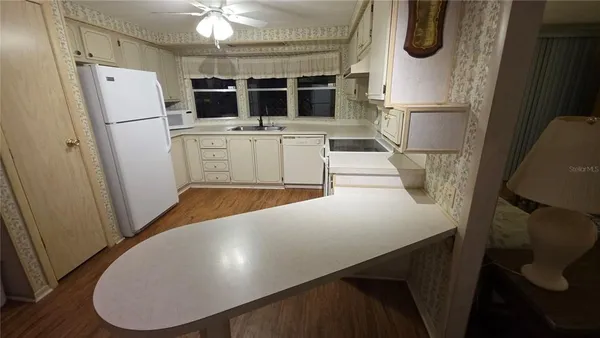 a kitchen with stainless steel appliances a refrigerator and a stove