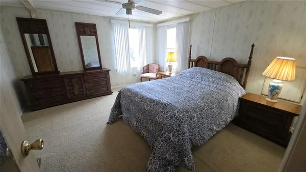 a bed sitting in a room next to a window