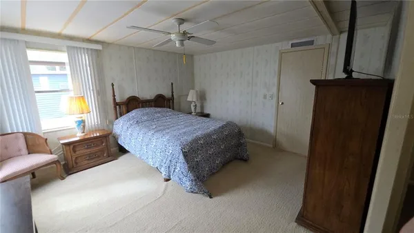 a spacious bedroom with a bed and furniture