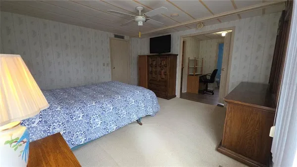 a bed room with a bed and a television