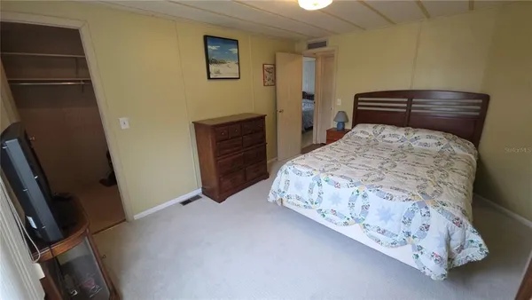 a bedroom with a bed and a dresser