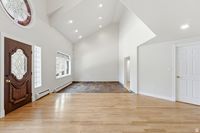 3535 Homestead Road Park City, UT 84098 - Photo 4 of 81 Entry foyer featuring a prominent wood-finish door with decorative glass, an oval stained-glass transom, and high vaulted ceilings with recessed lighting