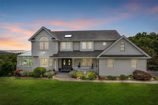 a front view of a house with a yard and garage