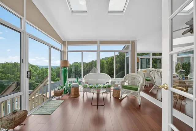 a living room with furniture and a large window with outer view