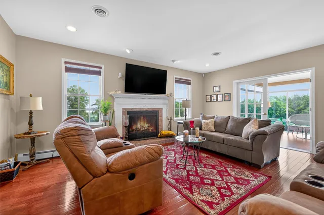 a living room with furniture a flat screen tv and a fireplace