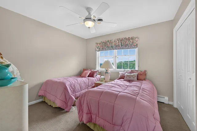 a bedroom with two beds and a chandelier