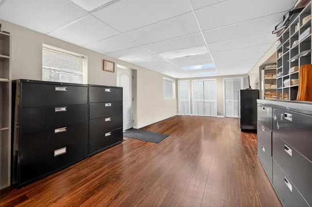 a view of empty room with wooden floor