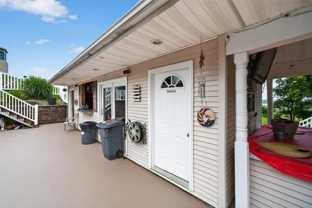 a view of a patio with table and chairs and potted plants