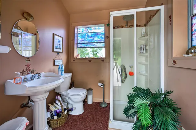 a bathroom with a sink toilet and a mirror