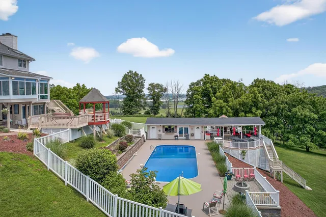 a view of house with outdoor space and swimming pool