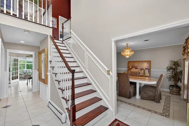 a view of a hallway with entryway and stairs