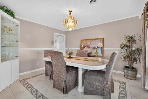a dining room with furniture and chandelier