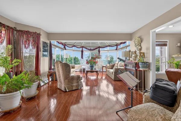 a living room with patio furniture and a potted plant