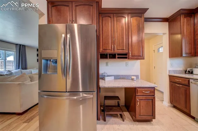 a kitchen with stainless steel appliances a refrigerator and a stove