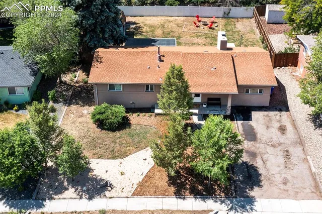 an aerial view of residential houses with outdoor space