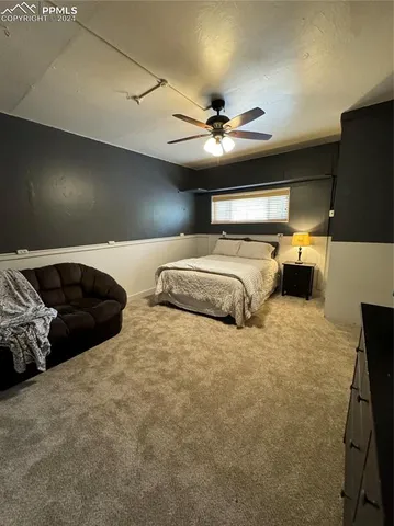 a bed room with furniture and a ceiling fan
