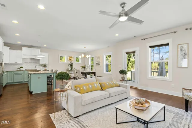 a living room with fireplace furniture and a wooden floor