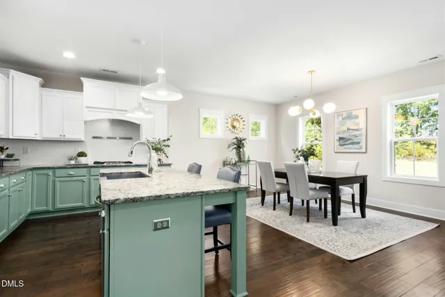 a living room with furniture a table and a potted plant