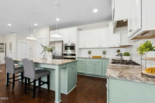 a kitchen with sink a microwave and cabinets