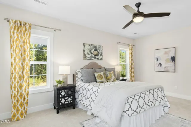 a bedroom with a bed and a painting on the wall