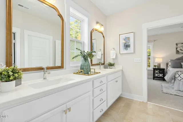 a bathroom with a double vanity sink mirror and shower