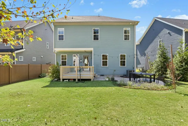 a backyard of a house with table and chairs