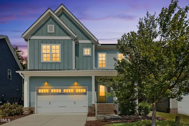 front view of a house with a tree