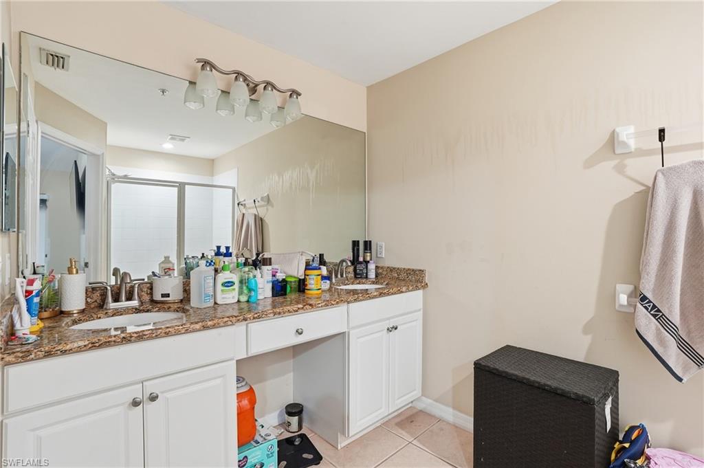 1013 Hampton Circle, Unit 127 Naples, FL 34105 - Photo 13 of 21 a bathroom with a double vanity sink mirror and double