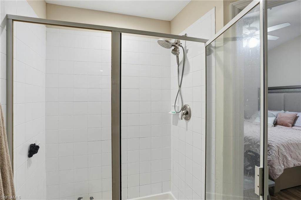 1013 Hampton Circle, Unit 127 Naples, FL 34105 - Photo 14 of 21 a bathroom with a glass shower door