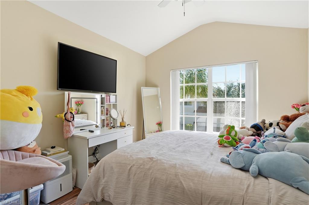 1013 Hampton Circle, Unit 127 Naples, FL 34105 - Photo 16 of 21 a bedroom with a bed a flat screen tv and a window