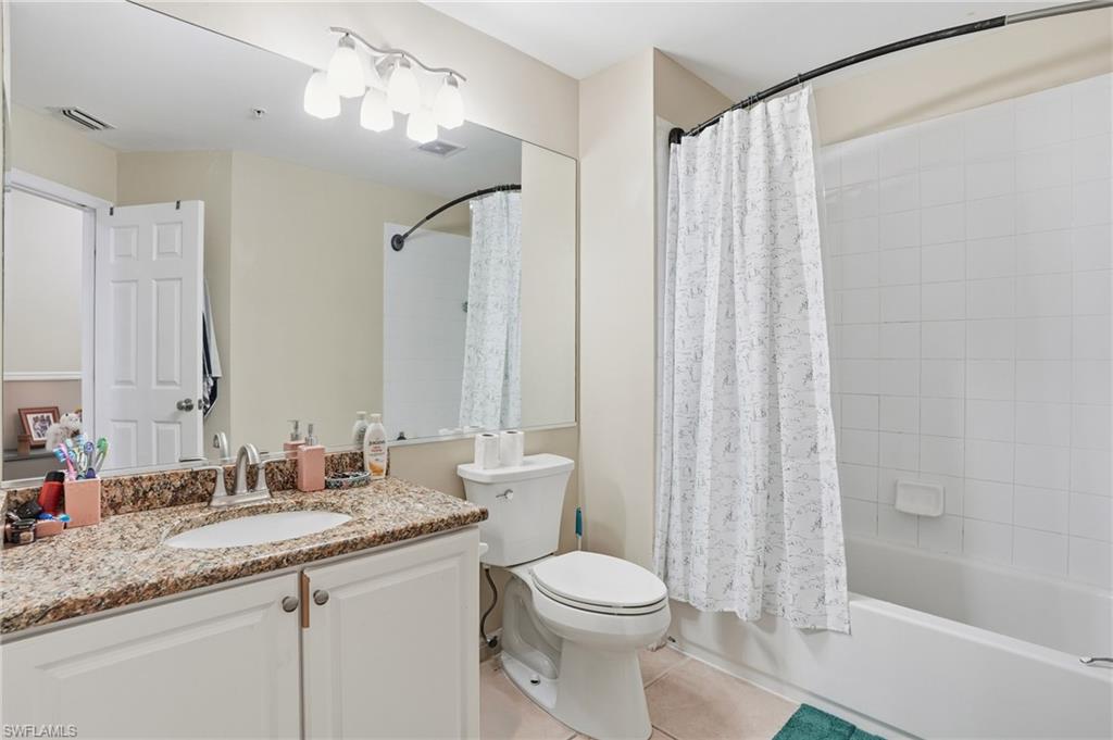 1013 Hampton Circle, Unit 127 Naples, FL 34105 - Photo 17 of 21 a bathroom with a granite countertop sink a toilet and shower