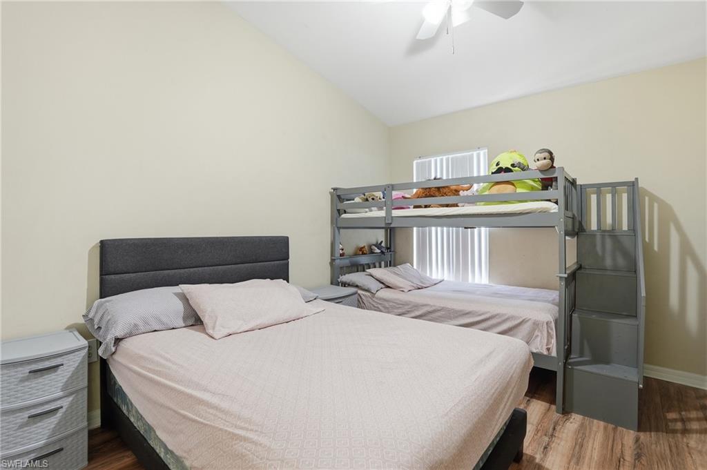 1013 Hampton Circle, Unit 127 Naples, FL 34105 - Photo 18 of 21 a bedroom with a bed and wooden floor