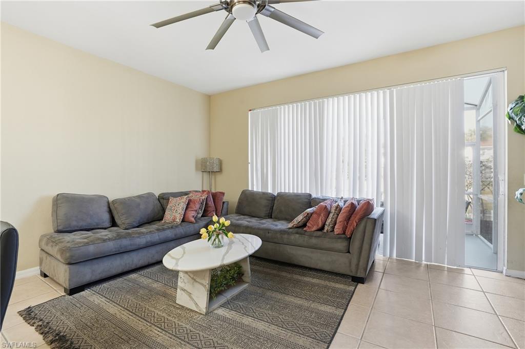 1013 Hampton Circle, Unit 127 Naples, FL 34105 - Photo 8 of 21 a living room with furniture and a large window