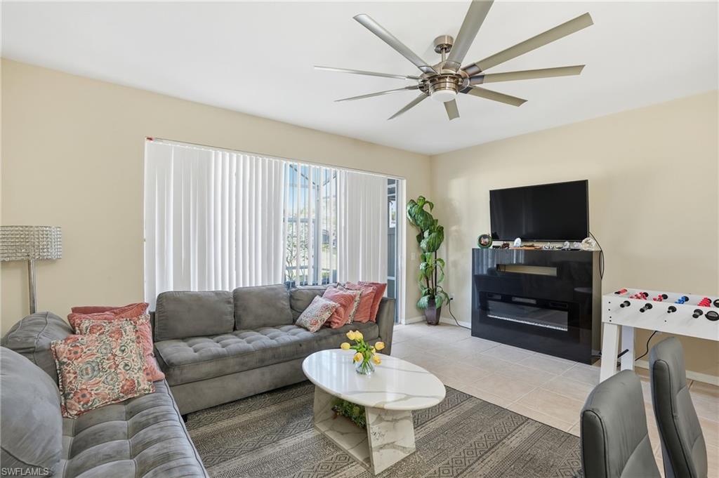 1013 Hampton Circle, Unit 127 Naples, FL 34105 - Photo 9 of 21 a living room with furniture a flat screen tv and a window