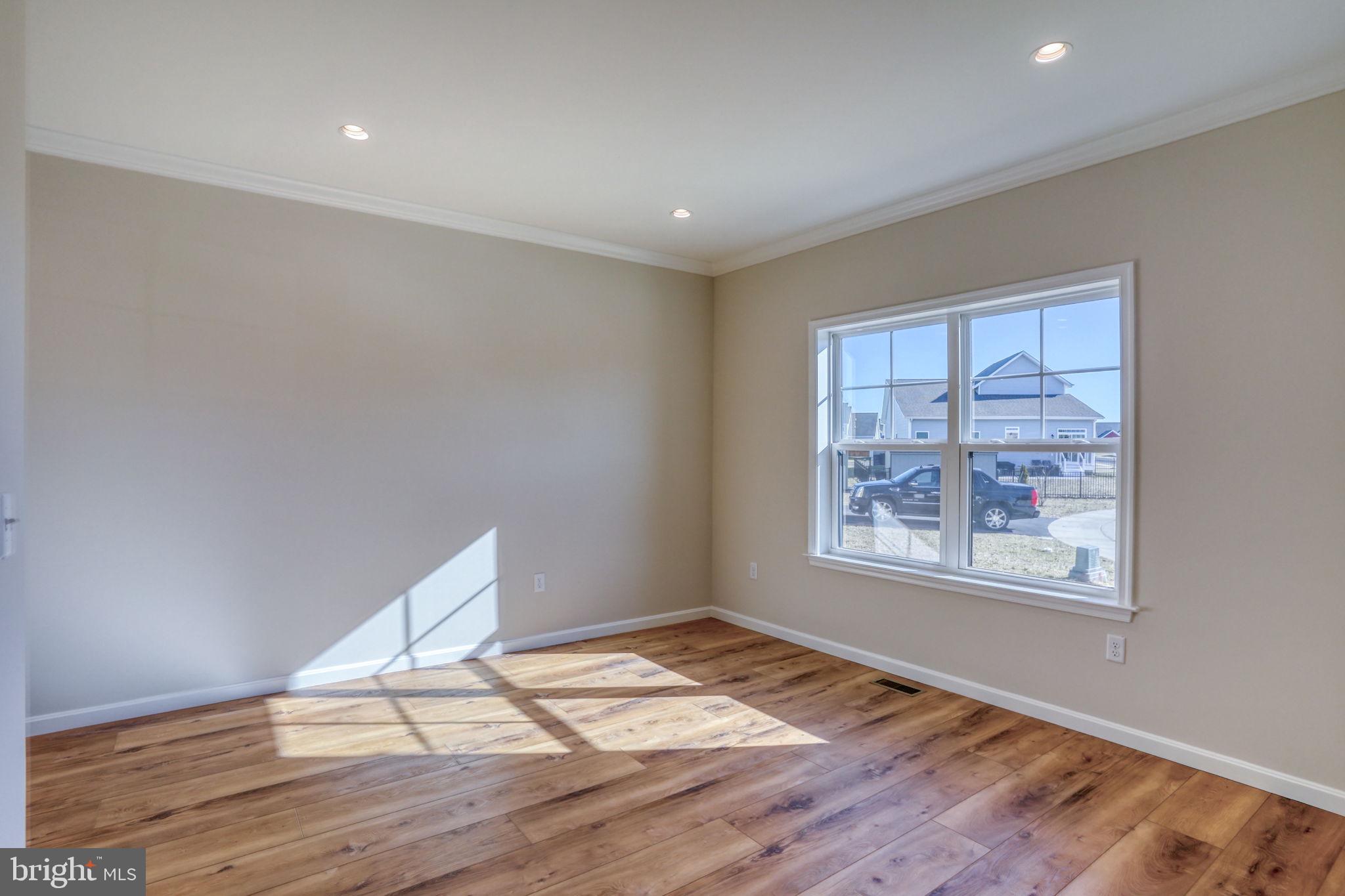 39 Doc Court Felton, DE 19943 - Photo 17 of 70 a view of empty room with wooden floor and fan