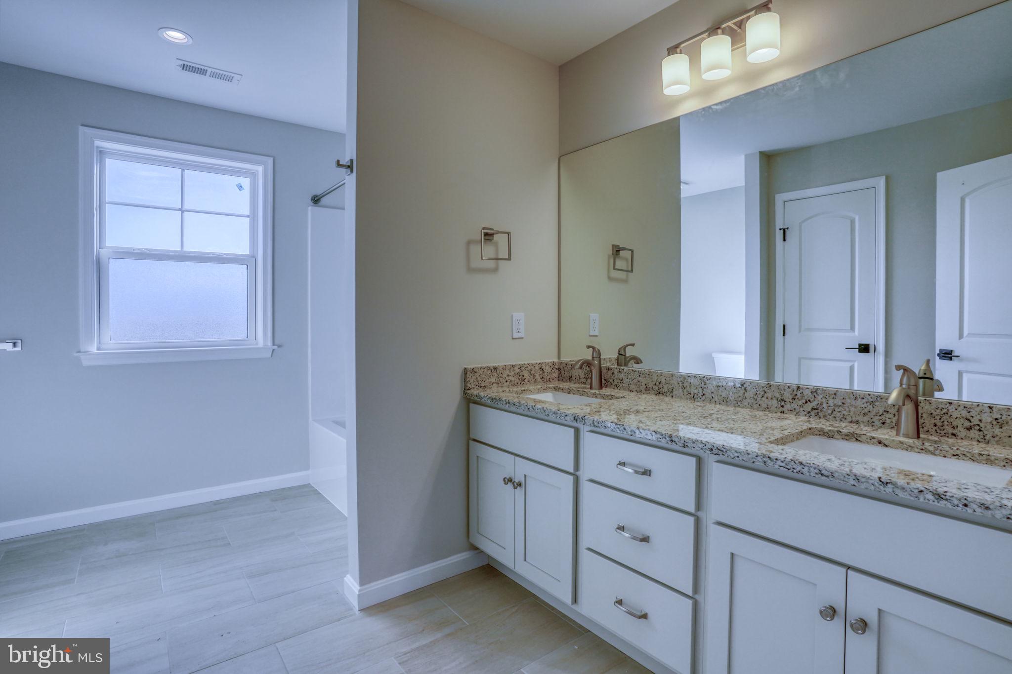 39 Doc Court Felton, DE 19943 - Photo 30 of 36 a bathroom with a granite countertop sink and a mirror